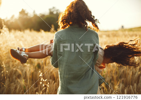 Family in a summer field. Sensual photo. Cute little girl. 121916776