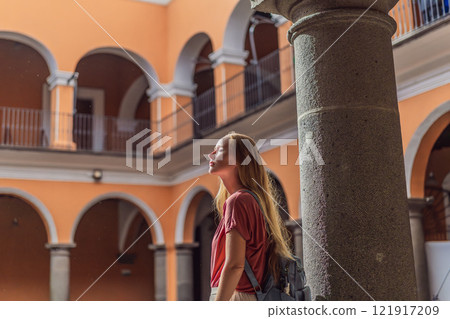 Female tourist exploring the historic Biblioteca Palafoxiana Palafoxiana Library in Puebla, Mexico. A cultural journey through history and literature in a UNESCO World Heritage site 121917209