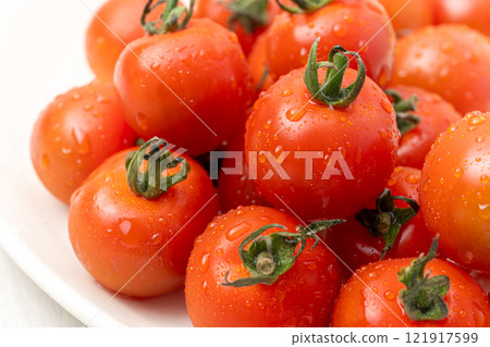 Tomatoes on a white plate 121917599