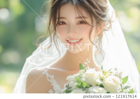 A young woman with a cute smile wearing a wedding dress 121917614