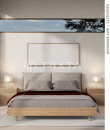 A contemporary, minimalist bedroom featuring a comfy bed with grey bedding and sleek home decor. A contemporary, minimalist bedroom featuring a comfy bed with grey bedding and sleek home decor. 121918564