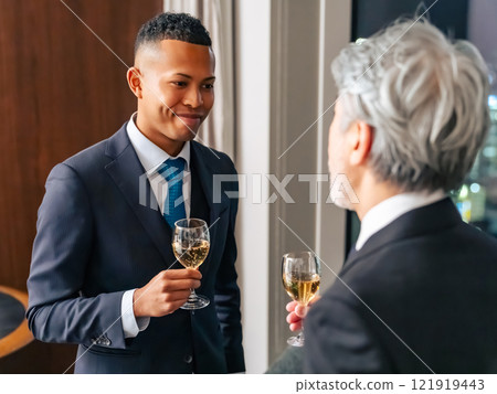 Multinational business people toasting with the city night view in the background Multinational business people toasting with the city night view in the background 121919443