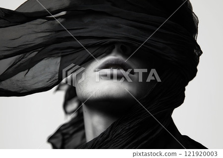 Portrait of a beautiful man with a black scarf on head 121920003