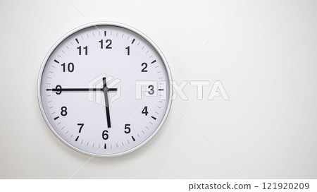 Minimalist White Clock with Silver Frame Striking 17.45/05.45 on White Background. Perfect for Time Management and Corporate Campaigns Minimalist White Clock with Silver Frame Striking 17.45/05.45 on White Background. Perfect for Time Management and Corporate Campaigns 121920209