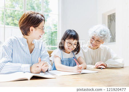 A smiling three-generation family who studies happily A smiling three-generation family who studies happily 121920477