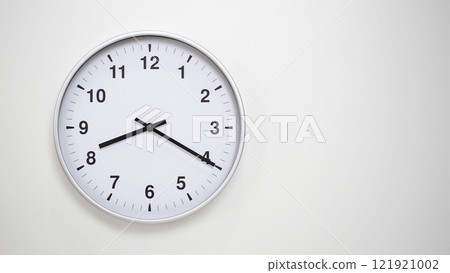 Minimalist White Clock with Silver Frame Striking 20.20/08.20 on White Background. Perfect for Time Management and Corporate Campaigns Minimalist White Clock with Silver Frame Striking 20.20/08.20 on White Background. Perfect for Time Management and Corporate Campaigns 121921002