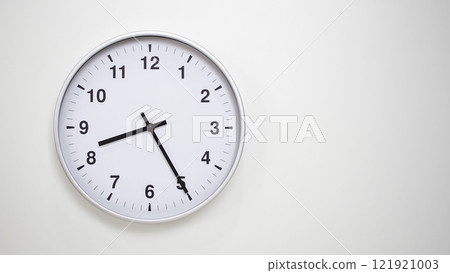 Minimalist White Clock with Silver Frame Striking 20.25/08.25 on White Background. Perfect for Time Management and Corporate Campaigns 121921003