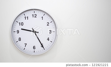 Minimalist White Clock with Silver Frame Striking 21.25/09.25 on White Background. Perfect for Time Management and Corporate Campaigns Minimalist White Clock with Silver Frame Striking 21.25/09.25 on White Background. Perfect for Time Management and Corporate Campaigns 121921221