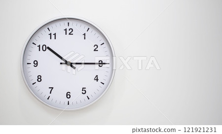Minimalist White Clock with Silver Frame Striking 10.15/22.15 on White Background. Perfect for Time Management and Corporate Campaigns Minimalist White Clock with Silver Frame Striking 10.15/22.15 on White Background. Perfect for Time Management and Corporate Campaigns 121921231