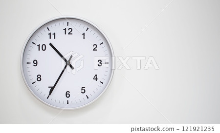 Minimalist White Clock with Silver Frame Striking 10.35/22.35 on White Background. Perfect for Time Management and Corporate Campaigns Minimalist White Clock with Silver Frame Striking 10.35/22.35 on White Background. Perfect for Time Management and Corporate Campaigns 121921235