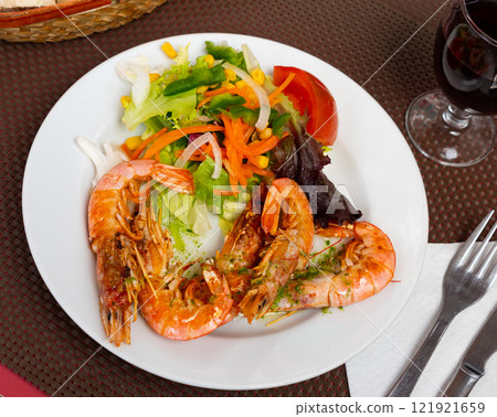 Shrimp served with vegetable salad on platter Shrimp served with vegetable salad on platter 121921659