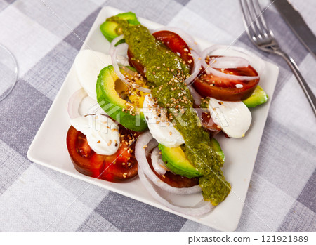 Caprese salad with avocado served on plate 121921889