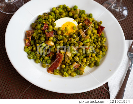 Typical Spanish side dish peas with jamon 121921934