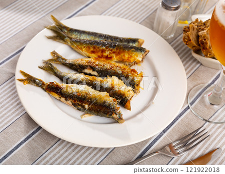 Grilled sardines served with bread and glass of beer Grilled sardines served with bread and glass of beer 121922018