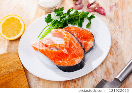 Raw salmon steaks on plate 121922023