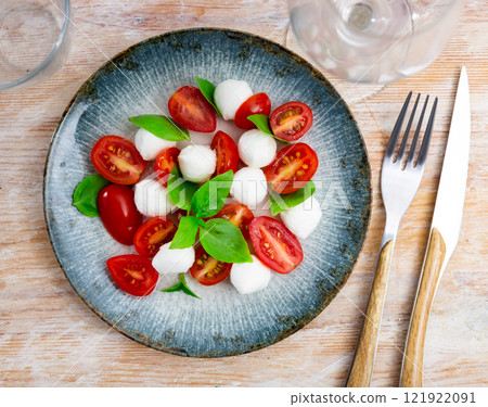 Refreshing Caprese salad of tender mozzarella and ripe tomatoes. Italian style appetizer or entree 121922091
