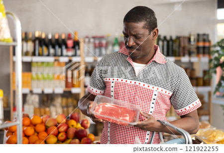 Adult man choosing entrecote in grocery store Adult man choosing entrecote in grocery store 121922255