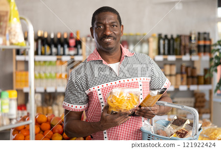 Adult man choosing pasta in store Adult man choosing pasta in store 121922424