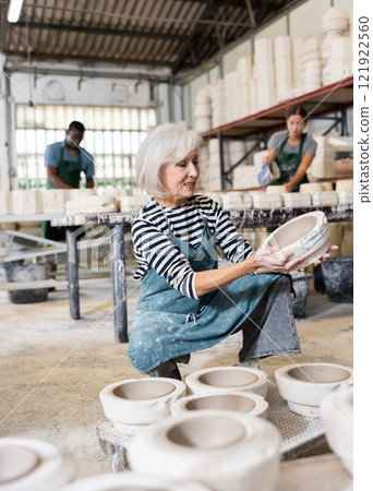 Positive woman potter with mould for new ware Positive woman potter with mould for new ware 121922560