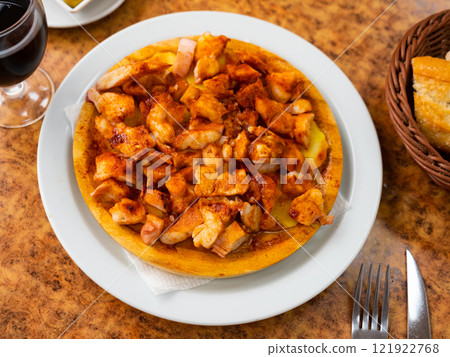Galician octopus served with potatoes on plate 121922768