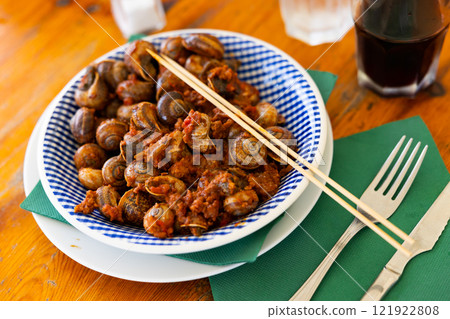 Shellfish snail cooked with minced meat and tomato dressing Shellfish snail cooked with minced meat and tomato dressing 121922808