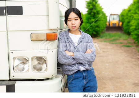 Portrait of female truck driver near the cab of his car Portrait of female truck driver near the cab of his car 121922881