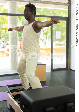 African american man is engaged in pilates training in gym 121922987