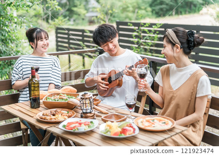 Young Asian men and women, friends, companions, colleagues having a barbecue, home party, glamping on a wooden deck Young Asian men and women, friends, companions, colleagues having a barbecue, home party, glamping on a wooden deck 121923474