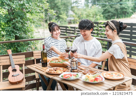 年輕的亞洲男女、朋友、同事和同事在木甲板上燒烤、家庭聚會和豪華露營 年輕的亞洲男女、朋友、同事和同事在木甲板上燒烤、家庭聚會和豪華露營 121923475