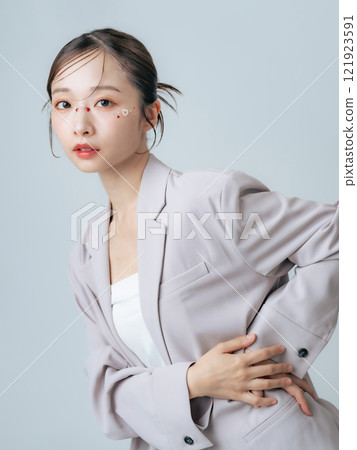 Fashion image of a woman wearing a jacket, cosmetics, beauty, skin care 121923591
