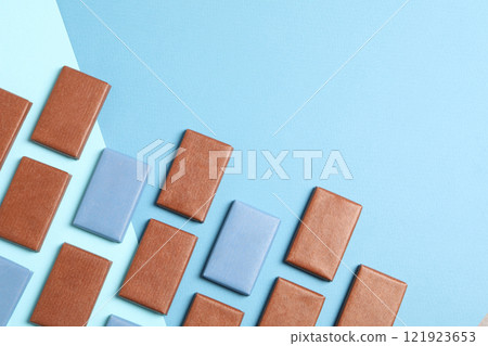 Blue and brown chocolate bars on a blue background Blue and brown chocolate bars on a blue background 121923653