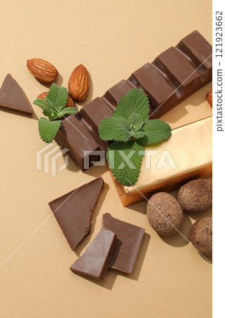 Chocolate bars with almonds and mint leaves 121923662