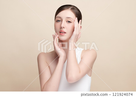 Beautiful young woman with clean fresh skin on beige background, Face care, Facial treatment, Cosmetology, beauty and spa, women portrait. Beautiful young woman with clean fresh skin on beige background, Face care, Facial treatment, Cosmetology, beauty and spa, women portrait. 121924074