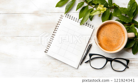 Modern office scene with a blank calendar on a desk, paired with a tablet and a pen 121924341
