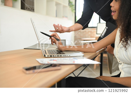 Two businesspeople analyzing business data during a team discussion Two businesspeople analyzing business data during a team discussion 121925992