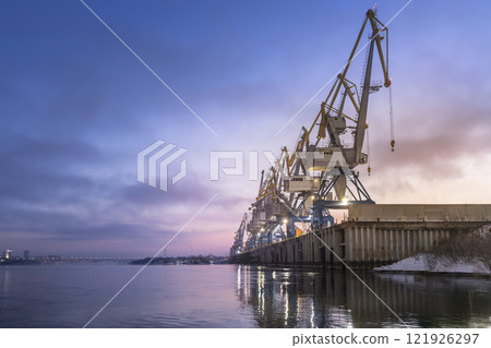 River or sea cargo cranes on the pier in the morning at dawn copyspace . Cargo transportation and logistics 121926297