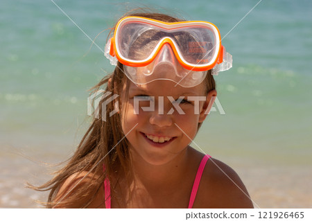 Portrait of caucasian child of 7-8 years in swimming mask looking at camera Portrait of caucasian child of 7-8 years in swimming mask looking at camera 121926465