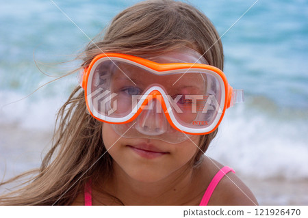Portrait of caucasian child of 7-8 years in swimming mask looking at camera Portrait of caucasian child of 7-8 years in swimming mask looking at camera 121926470