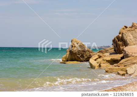 Sea Rocks on beach with blue sea 121926655