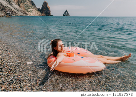 Woman Beach Flamingo Float Relaxing on Calm Sea Water 121927578