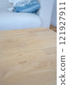 The edge of the table with a sofa in the background 121927911