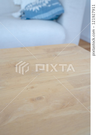 The edge of the table with a sofa in the background The edge of the table with a sofa in the background 121927911