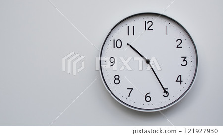 Minimalist Analog Wall Clock with White Face and Simple Black Hands Showing 10.25/22.25 - Ideal for Time Management and Modern Decor Concepts Minimalist Analog Wall Clock with White Face and Simple Black Hands Showing 10.25/22.25 - Ideal for Time Management and Modern Decor Concepts 121927930