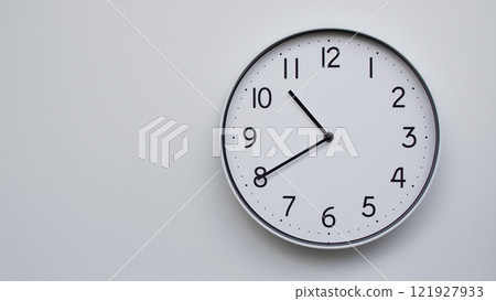 Minimalist Analog Wall Clock with White Face and Simple Black Hands Showing 10.40/22.40 - Ideal for Time Management and Modern Decor Concepts 121927933