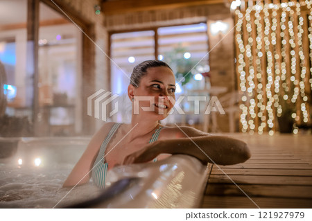Calm moment for woman relaxing in a hot tub. Single woman celebrating Valentine's Day alone. 121927979