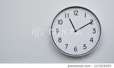 Minimalist Analog Wall Clock with White Face and Simple Black Hands Showing 11.10/23.10 - Ideal for Time Management and Modern Decor Concepts 121928083