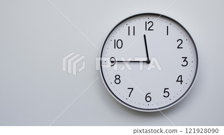 Minimalist Analog Wall Clock with White Face and Simple Black Hands Showing 11.45/23.45 - Ideal for Time Management and Modern Decor Concepts 121928090