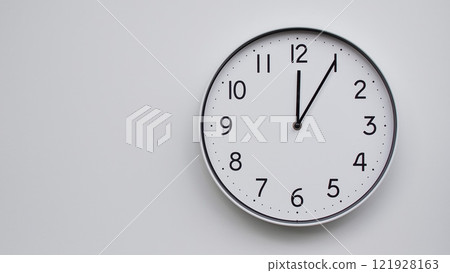 Minimalist Analog Wall Clock with White Face and Simple Black Hands Showing 12.05/00.05 - Ideal for Time Management and Modern Decor Concepts 121928163