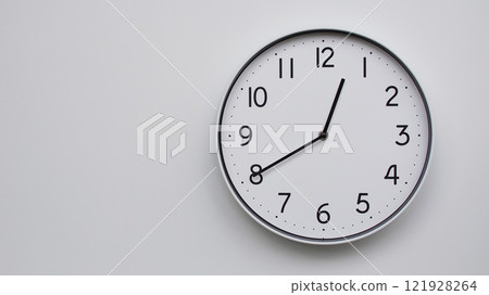 Minimalist Analog Wall Clock with White Face and Simple Black Hands Showing 12.40/00.40 - Ideal for Time Management and Modern Decor Concepts 121928264