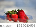 Packed strawberries on snow 121928454